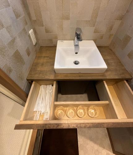 a bathroom with a sink on a wooden counter at 箱根仙石原心温まる雅宿 in Hakone