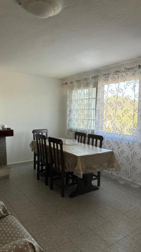 a dining room with a table and chairs and a window at Casa Trudda in Trudda