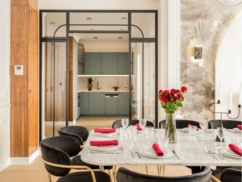 une salle à manger avec une table et des chaises noires dans l'établissement Merveil - Signature Suite - Champs Elysees -Kleber, à Paris