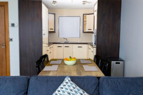 a kitchen with a table with a bowl of fruit on it at Tur an Tsaile - Galway Lakeside Apartments in Galway