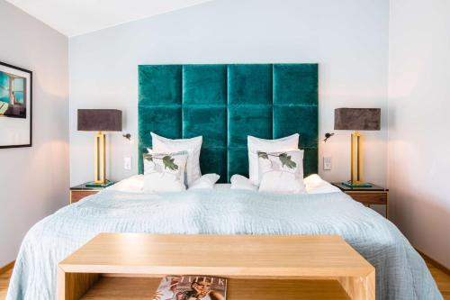 a bedroom with a large bed and two lamps at Scandic Stora Hotellet in Nyköping