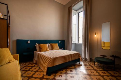 a bedroom with a bed and a window at Palazzo Emanuele Luxury in Gallipoli