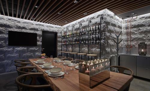 a dining room with a long wooden table and chairs at Scandic Stora Hotellet in Nyköping
