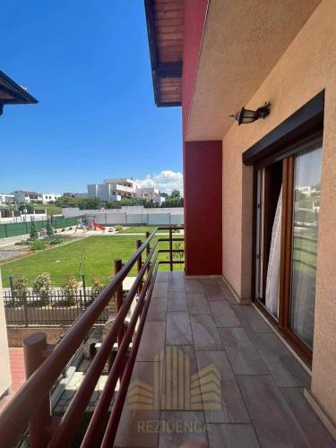 a balcony of a house with a view of a field at Nic Villa Prishtinë in Laplje Selo