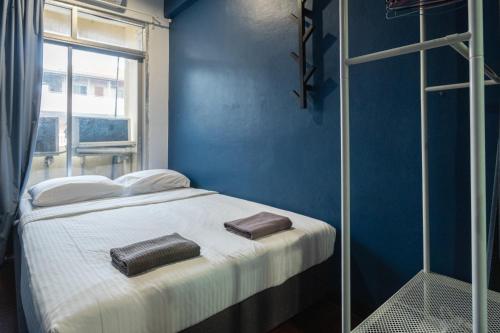 a blue bedroom with a bed with two bags on it at T4 Two Bedrooms Full kitchen/1 min to BTS in Bangkok