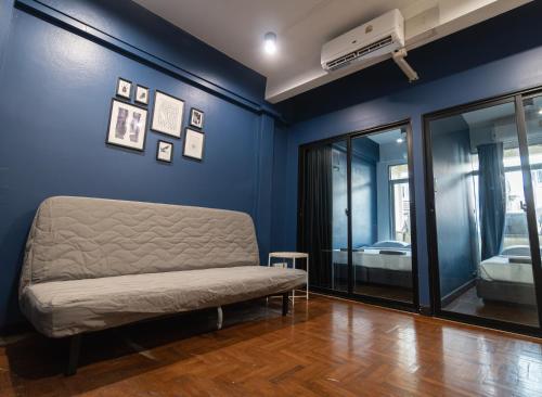a blue room with a couch and a bed at T4 Two Bedrooms Full kitchen/1 min to BTS in Bangkok