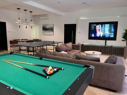 a living room with a pool table and a tv at Premium 3 bedroom apartment ikoyi in Lagos