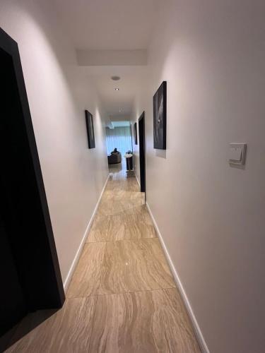 a hallway with white walls and a wooden floor at Premium 3 bedroom apartment ikoyi in Lagos