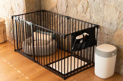 a black bird cage with a chair in it at UMITO VILLA KAMAKURA Zaimokuza in Kamakura