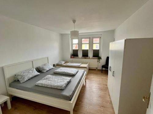 a bedroom with two beds and a refrigerator at Ferienwohnung für 5 Personen in Dresden