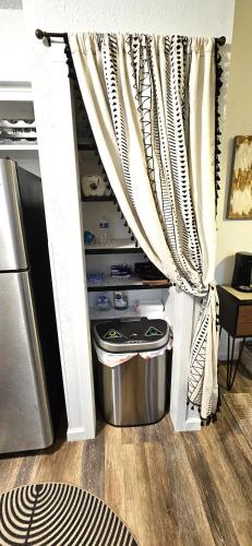 a kitchen with a pantry with a curtain at Breathe Easy Here in Buda 3bd 2ba Home in Buda