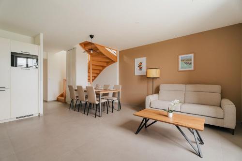 un salon avec un canapé et une table dans l'établissement Gites des Pierres Sonnantes, à Saint-Cast-le-Guildo