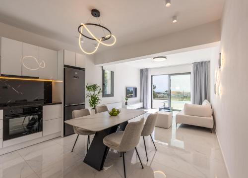 a kitchen and dining room with a table and chairs at Villa Myrto - Elysian Villas Kefalonia, 200m from Beach, New 2024 in Minia