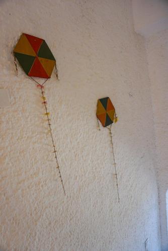 two umbrellas hanging on a wall at Vagia Traditional, Aegina Island in Vaia