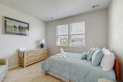 a bedroom with a bed and a window at Millville by the Sea --- 36682 Calm Water Dr in Millville