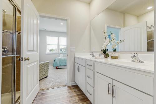 a white bathroom with a sink and a mirror at Millville by the Sea --- 36682 Calm Water Dr in Millville