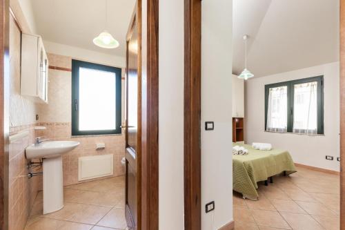 a bathroom with a sink and a table at Bynos Sea View in Santa Maria Navarrese