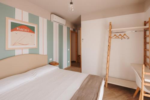 a bedroom with a bed and a clock on the wall at La Casa Di Pinocchio in Enna