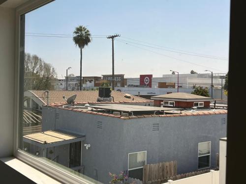 a view of a city from a window at Newly constructed 2 bedroom by La Cienega Plaza with parking, modern kitchen, washer dryer and very central to attractions in Los Angeles