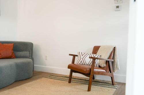 a living room with a chair and a couch at The Jaxon in West Palm Beach