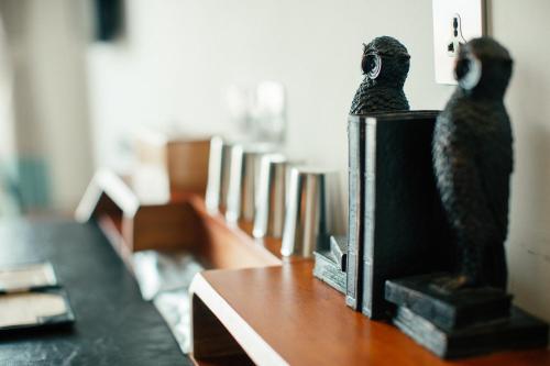 two statues of birds sitting on top of a table at NK Hostel in Taipei
