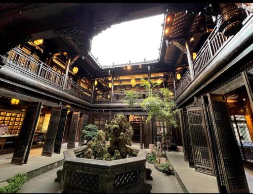 a large building with a fountain in the middle of it at Kelly Jinyue Hotel in Chengdu