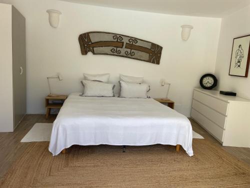 a bedroom with a large white bed with white sheets at Luxurious Provencal cottage with private Pool, Terrace & Garden in Vence