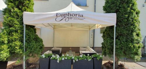 a white tent with a table in front of a building at Euphoria Residence in Sosnowiec