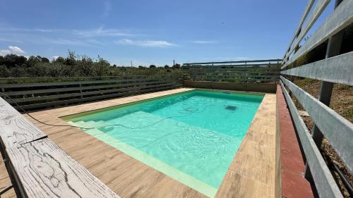 a swimming pool on top of a wooden deck at Villa Trappeto in Trappeto