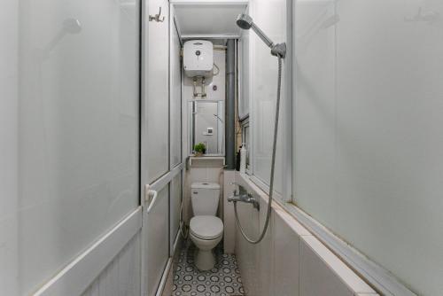 a small bathroom with a toilet and a shower at HiHome Bellevie Lakeview Escape in Hanoi OldQuarter in Hanoi