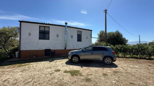 a small car parked in front of a house at Villa Trappeto in Trappeto