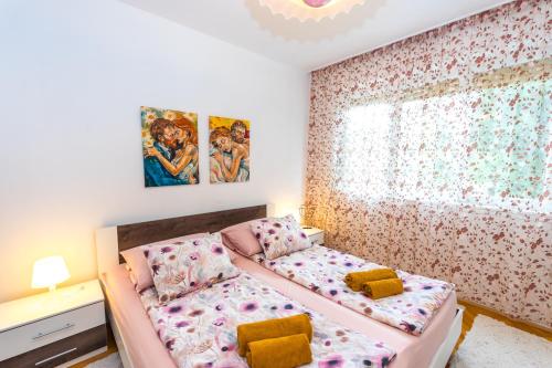 a small bedroom with a bed and a window at Cozy 2 Bedroom APT 15 Min Walk From Split Center and Beach in Split