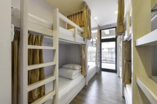 a room with two bunk beds and a hallway at Taichung Box Design Hotels in Taichung