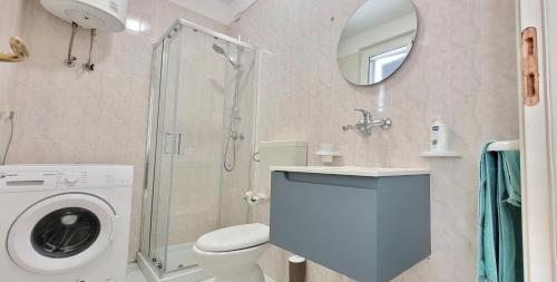 a bathroom with a washing machine and a shower at De finibus terrae in Leuca