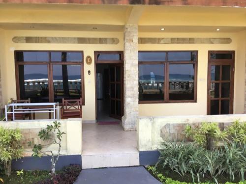 a house with a view of the ocean at Bali Palms Resort-412 in Candidasa