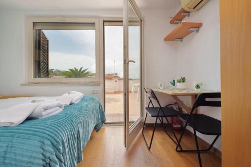 a bedroom with a bed and a desk and a window at Magic Trastevere suite on roof terrace in Rome