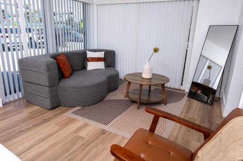 a living room with a gray couch and a table at The Jaxon in West Palm Beach