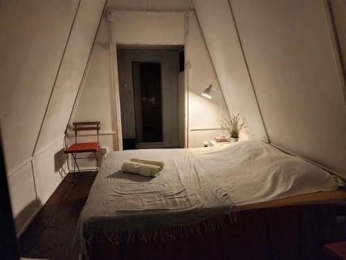 a bedroom with a large white bed in an attic at Twinbeach Sanctuary in Mersing