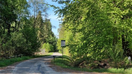 a road with a sign on the side of it at Harcówka in Miękisz Nowy