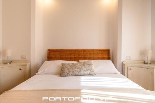 a bedroom with a large bed with two night stands at Vela by PortofinoVip in Portofino