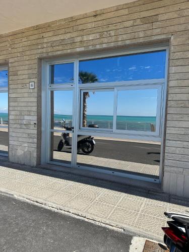 a building with a window with a scooter in it at Hotel Piccolo Paradiso in Bordighera