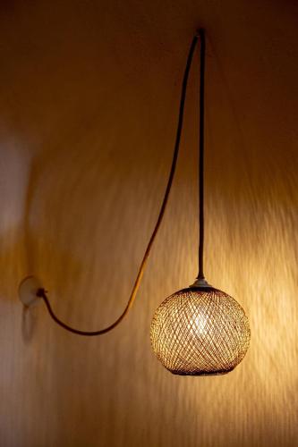 a light hanging from a wall in a room at Parastia Luxury Villa Santorini - Private Jacuzzi in Éxo Goniá
