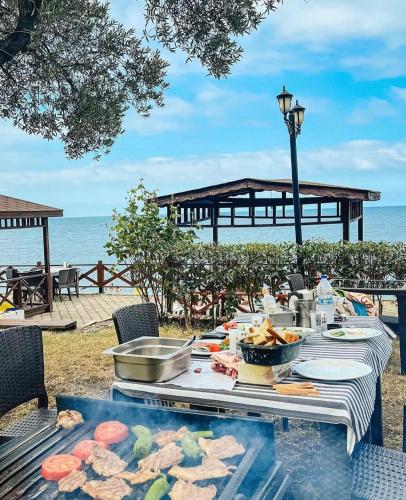 a picnic table with food on the beach at Pasa Tatil Koyu in Akcaabat