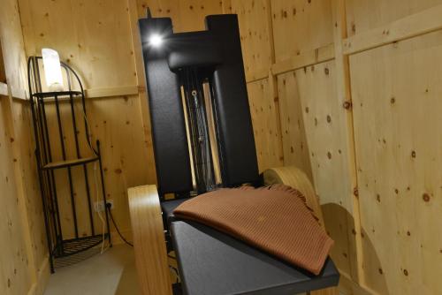 a room with a wooden wall with a bench and a light at Best Western Plus Hotel Erb in Parsdorf