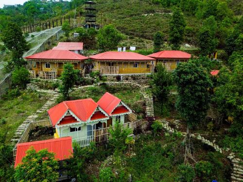 a group of houses with red roofs on a hill at Naya Gaun Eco Resort in Pokhara