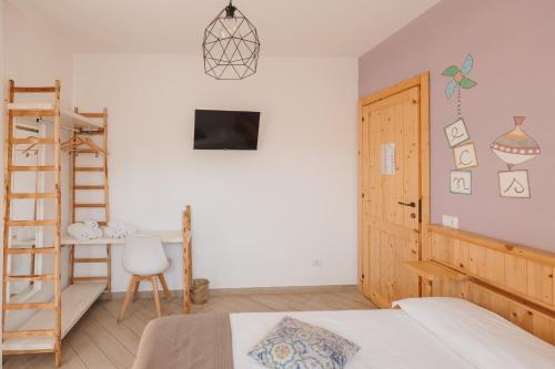 a bedroom with a bed and a ladder and a desk at La Casa Di Pinocchio in Enna