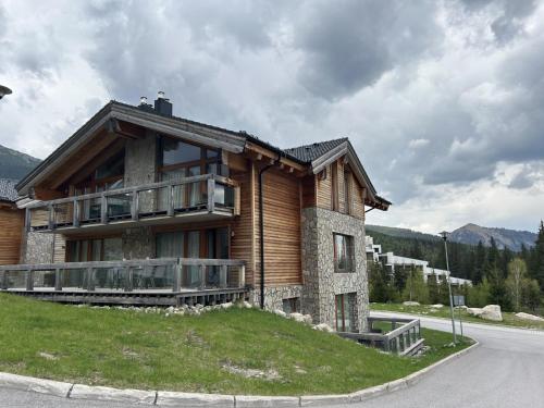 a house on top of a grassy hill with at Ski-In Jasna Otupne Apartment & Lodge in Demanovska Dolina