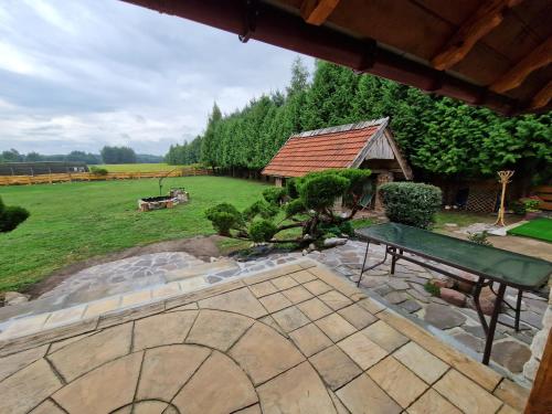 a garden with a bench and a gazebo at Harcówka in Miękisz Nowy