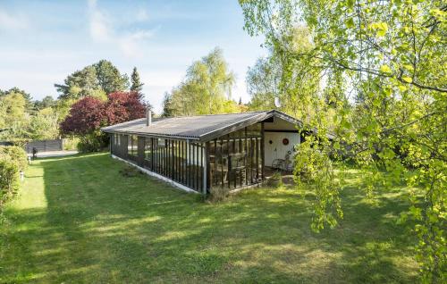 a house with a fence in a yard at Pet Friendly Home In Nykøbing Sj in Nyrup