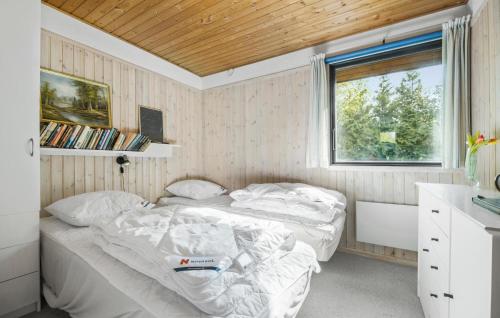 two beds in a small room with a window at Pet Friendly Home In Nykøbing Sj in Nyrup